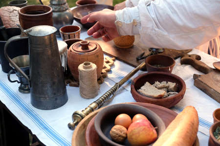 Still life with rural repast of antique french wood and metal utensils, vintage scales and simple...