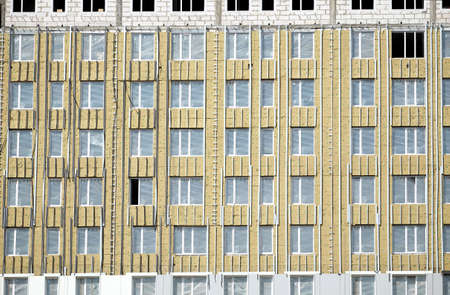 Process of mounting insulation on apartment building facade