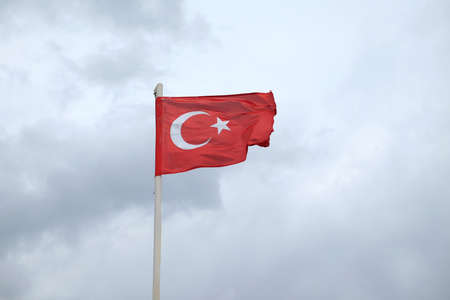 Turkish red flag waving on gloomy rainy day