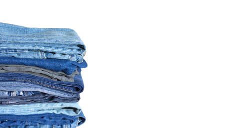Stack on many colored blue jeans isolated on white background with empty space for text at right side of Photoの写真素材