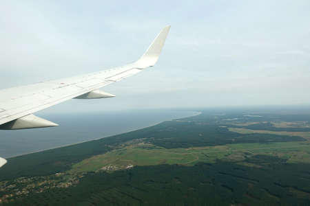 View from the airplane to the Gulf of Riga coastline with long sandy beach on the Baltic sea in low...