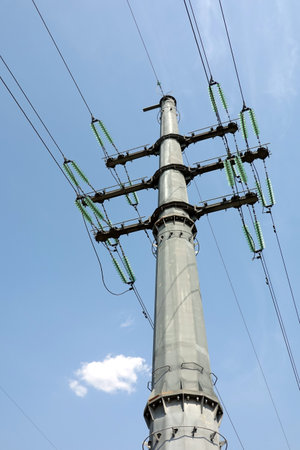High-voltage strong power line metal prop painted gray with many wires on electrical insulation view from bottom to top close upの写真素材