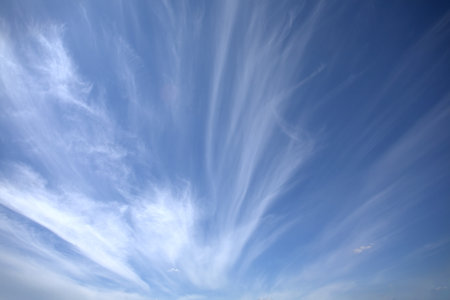 Beautiful sky landscape with white clouds high in the stratosphere on bright sunny day horizontal photoの写真素材