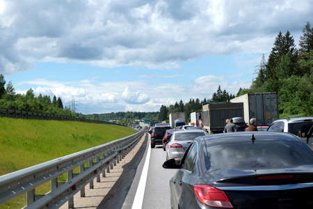 Moscow suburban, Russia - June the 6th, 2016: Traffic jam on countryside highway. Long line of many cars dense motionless standing on the road on sunny summer dayのeditorial素材