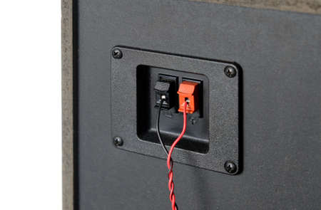 Red and black twisted wire connected to connection socket on rear side of speakerの写真素材