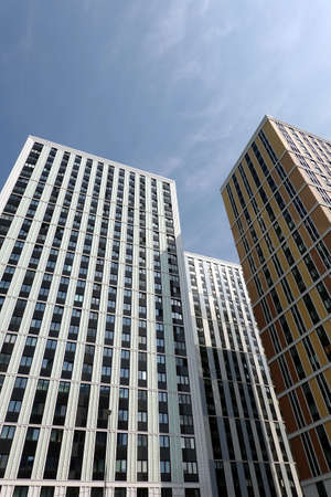 High bottom up perspective view of modern city skyscraper buildings with many windows in the urban cluster vertical viewの写真素材