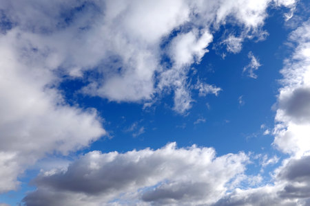 Beautiful celestial landscape with white cumulonimbus clouds high in the stratosphere on a sunny summer dayの写真素材
