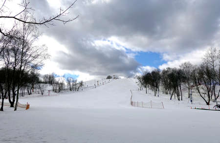 Empty ski slope front view on overcast winter day at ski resortの写真素材
