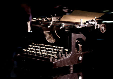 Vintage mechanical typewriter with installed paper sheet on black background concept photography close-up viewの写真素材