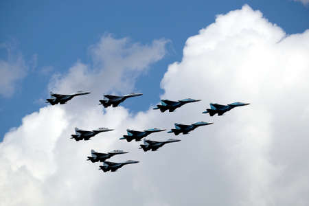 MOSCOW, RUSSIA - MAY 7, 2021: Group of Russian military supersonic high-altitude interceptors SU-34, SU-35, SU-30SM shows figure Tactical Wing in flight on parade rehearsalのeditorial素材