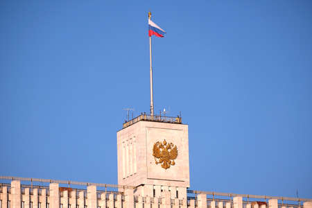 Russian flag on the building of the Government of the Russian Federation against clear blue skyの写真素材