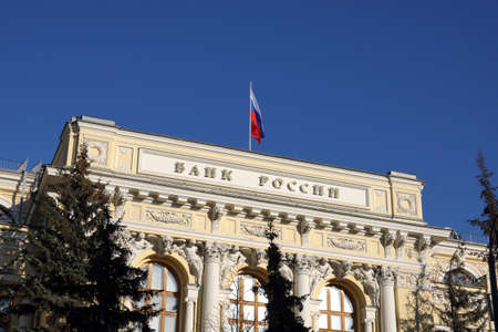 Building of Central Bank of Russia in Moscow with state flag on the top of the building under clear blue sky on bright sunny dayの写真素材