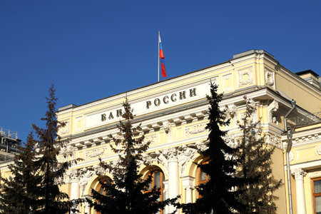 Moscow / Russia - March the 19th 2022: Inscription visible as ban Russia on facade of Russian Central Bank beige building under state flagのeditorial素材