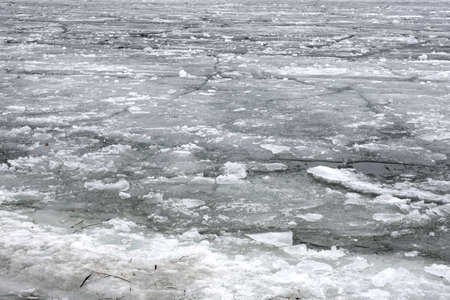 Landscape with treacherous melting broken ice floes floating dense on the river on a spring dayの写真素材