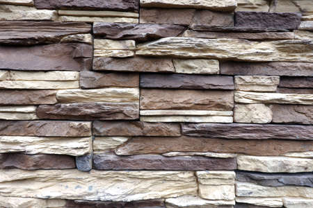 Wall stonework finishing from colorful natural stone trim as background front view close upの写真素材