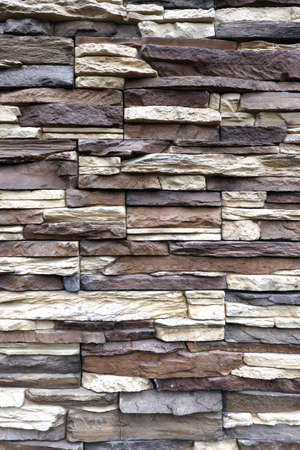 Wall stonework finishing from colorful natural stone trim as background front view close upの写真素材