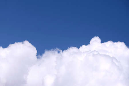 Beautiful contrast sky landscape with white clouds on the bottom of photo and gradient blue sky above on bright sunny day horizontal viewの写真素材