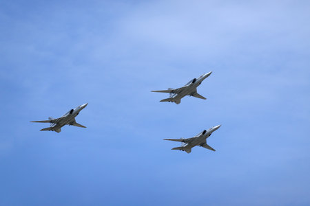 MOSCOW, RUSSIA - MAY 7, 2022: Three long-range supersonic bombers-missile carriers TU-22M3 with variable sweep wing in flight in blue sky on on parade rehearsalのeditorial素材