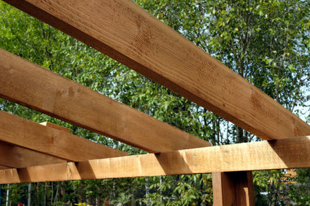 The process of building a wooden canopy from brown boards in the countryside in summer dayの写真素材