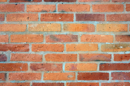 Part of red bricks wall with concrete joints as background front view close up horizontal photoの写真素材