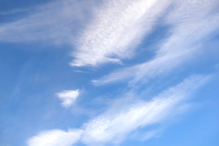 Beautiful sky landscape with white calm soft fluffy spindrift clouds high in the stratosphere on a sunny serenite dayの写真素材