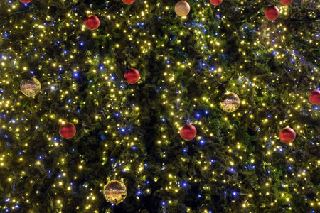 Christmas trees as new year background with many colorful christmas balls and lighting front view close upの写真素材