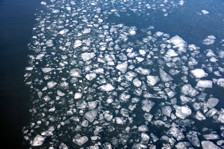 Lot of broken small ice floes floating on the river aerial aerial viewの写真素材