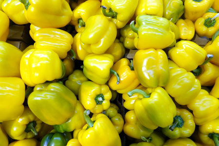 Ripe yellow hungarian pepper in the shop front in fruit section in the food store front view close upの写真素材