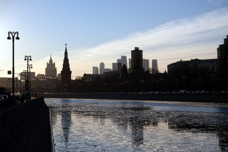 Moscow river, embankment and silhouettes of buildings and Kremlin towers under clear cloudless skyの写真素材