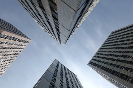 Bottom up perspective around view of modern city high building walls with many windows in business cluster conceptual photoの写真素材