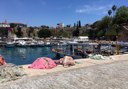 ANTALYA, TURKEY - May the 2nd, 2023: Mobile photo of motor boats on parking in Antalya harbor and fishing nets on the pier on sunny summer dayのeditorial素材