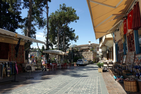 ANTALYA, TURKEY - May the 2nd, 2023: Empty back street with handmade craft carpets and other souvenirs in the tourist area in Antalya old city in heat dayのeditorial素材