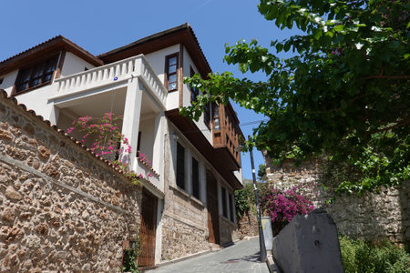 Going up on empty back street through historical houses in the tourist area in Antalya old city in heat sunny day horizontal viewの写真素材