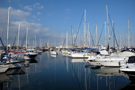 Tight yacht parking in calm water in Larnaca marina on hot summer dayの写真素材