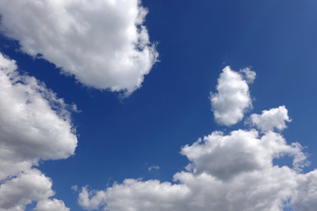 Beautiful heaven landscape with white and gray fluffy clouds in deep blue skyの写真素材