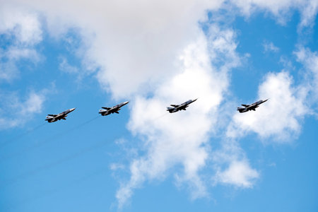 MOSCOW, RUSSIA - May 7, 2021: Group of Russian military tactical frontline bombers SU-24 fast flying in the blue sky with white clouds on parade rehearsalのeditorial素材