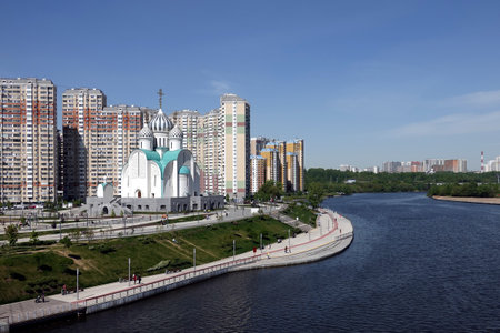 View to Nikolsky Cathedral in the Pavshinsky floodplain near residential buildings in Krasnogorsk city on sunny dayの写真素材