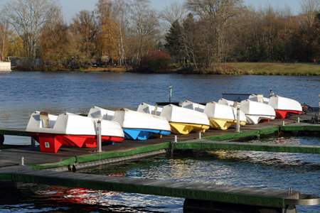 End of summer season. Autumn landscape with many overturned boats on pier ready for conservation for next seasonの写真素材