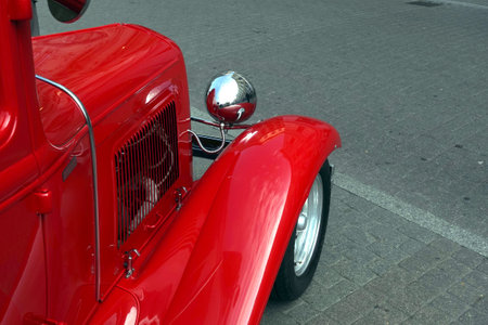 Side view to fragment of retro hot rod car color red close upの写真素材