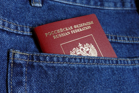 Russian Federation foreign passport red color in the blue jeans back pocket close-up photoの写真素材