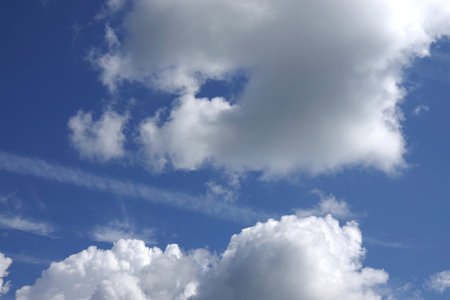 Beautiful heaven landscape with big white and gray fluffy clouds in deep blue skyの写真素材