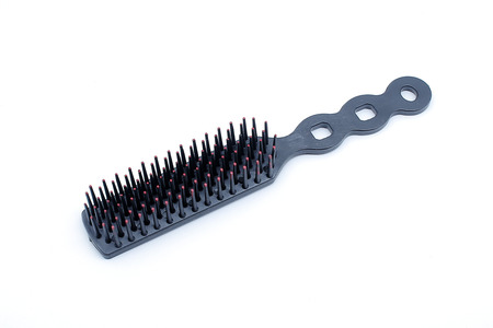 Plastic hairbrush on white background with selective focusの写真素材