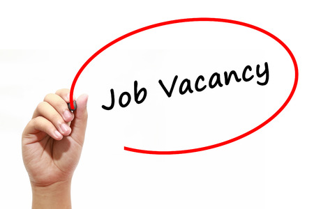 Man Hand writing Job Vacancy with marker on transparent wipe board. Business, internet, technology concept.の写真素材