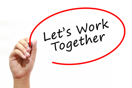 Man Hand writing Lets Work Together with marker on transparent wipe board. Business, internet, technology concept.の写真素材
