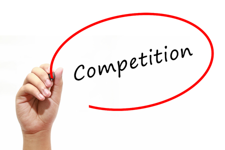 Man Hand writing Competition with marker on transparent wipe board. Business, internet, technology concept.の写真素材