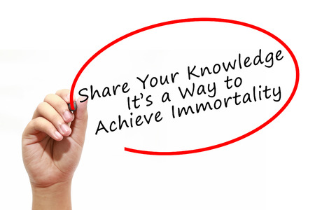 Man Hand writing Share Your Knowledge. Its a Way to Achieve Immortality with marker on transparent wipe board. Business, internet, technology concept.の写真素材