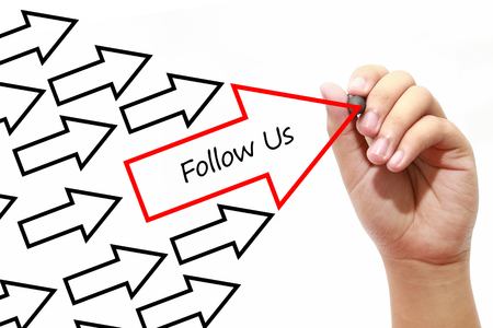Man drawing Follow Us arrows concept on virtual screen.Business, banking, finance and investment concept.の写真素材