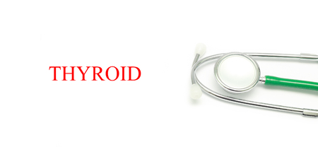 Close up Stethoscope and words Thyroid over white backgroundの写真素材
