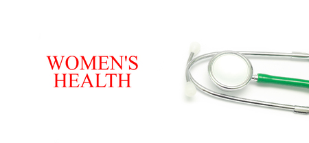 Close up Stethoscope and words Women's Health over white backgroundの写真素材