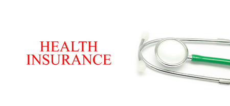 Close up Stethoscope and words Health Insurance over white backgroundの写真素材